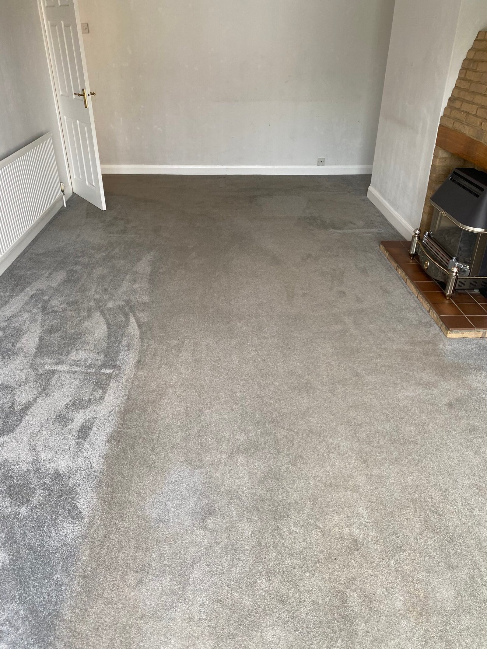 Carpet in a Bedford home before cleaning, dull and marked